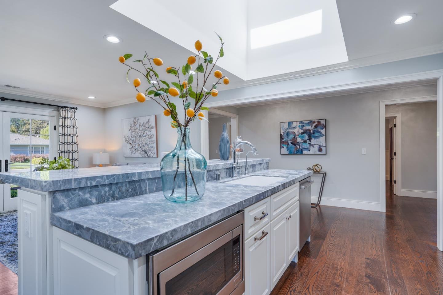 1481 Brookmill Road Los Altos, CA 94024 - Photo 9 of 55 a kitchen with stainless steel appliances granite countertop a sink a microwave a dining table and chairs