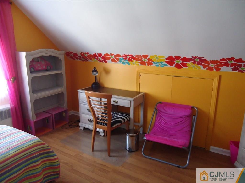 141 Long Hill Road Colonia, NJ 07067 - Photo 14 of 22 a bedroom with a bed and a dresser in it