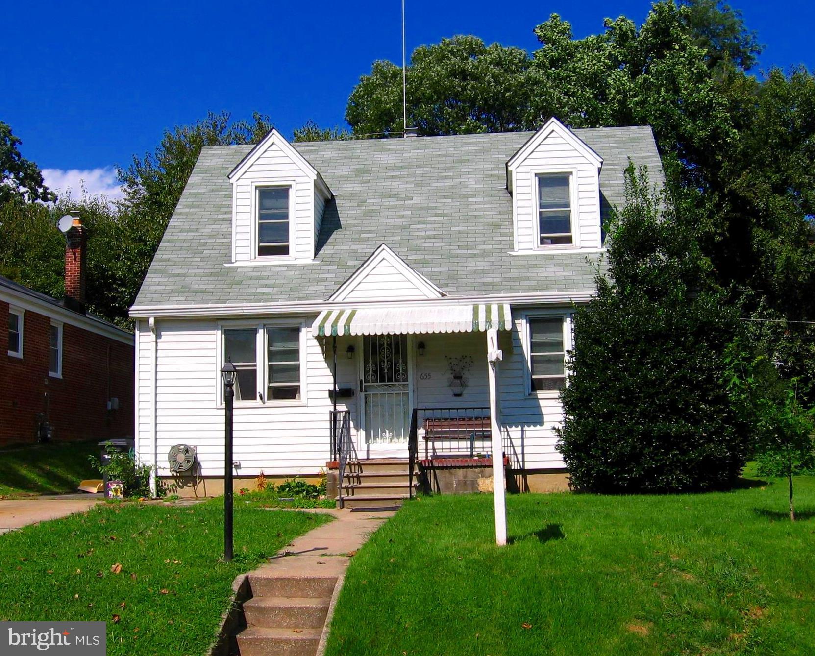 655 Coleraine Road Baltimore, MD 21229 - Photo 1 of 3 a front view of a house with a garden