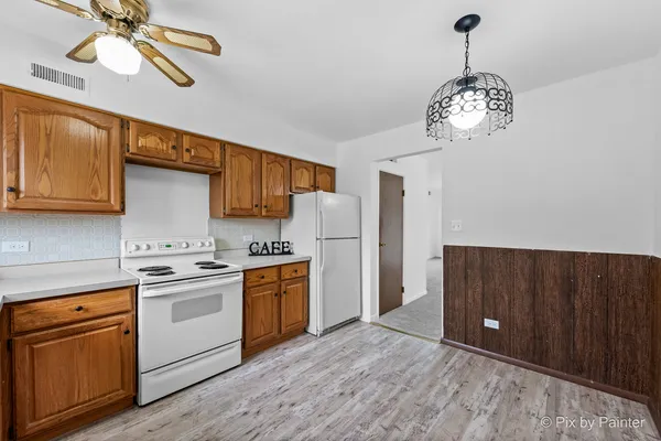 a kitchen with stainless steel appliances granite countertop a refrigerator a stove a sink dishwasher and a wooden cabinets