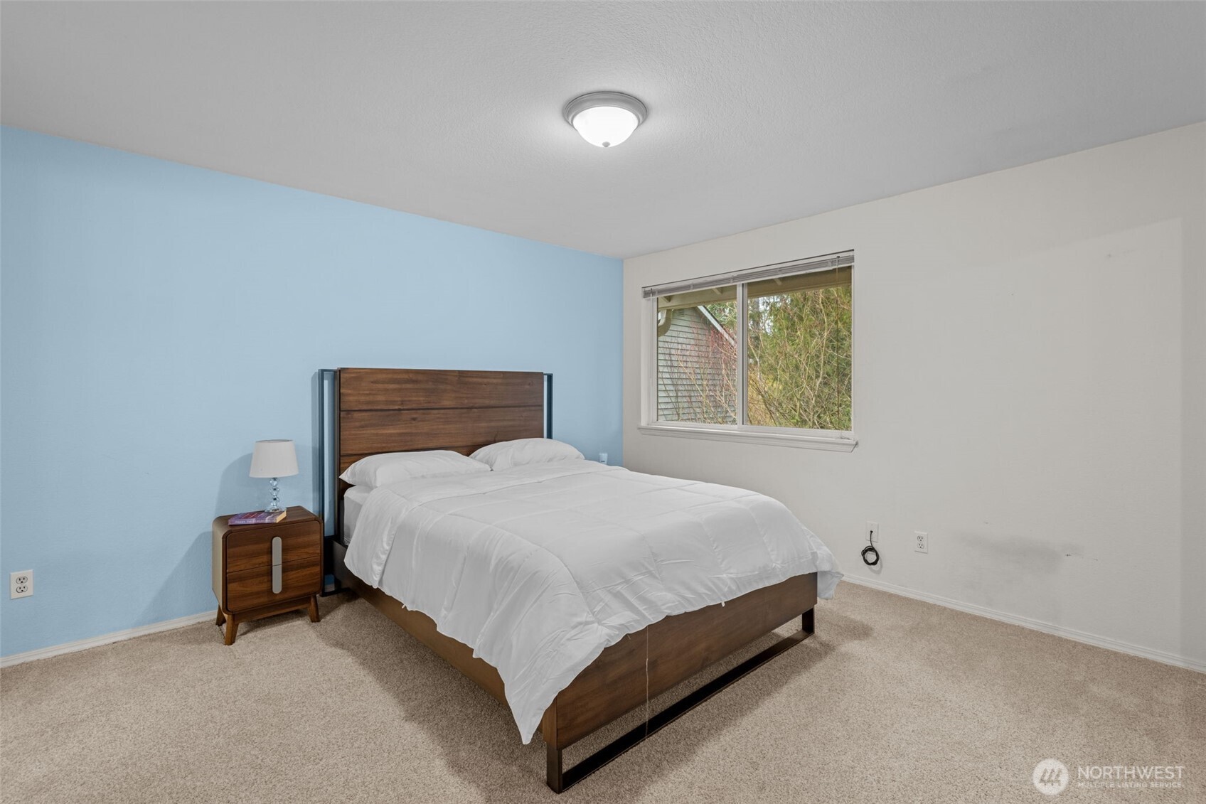 18429 20th Drive Southeast Bothell, WA 98012 - Photo 13 of 26 a bed sitting in a bedroom next to a window