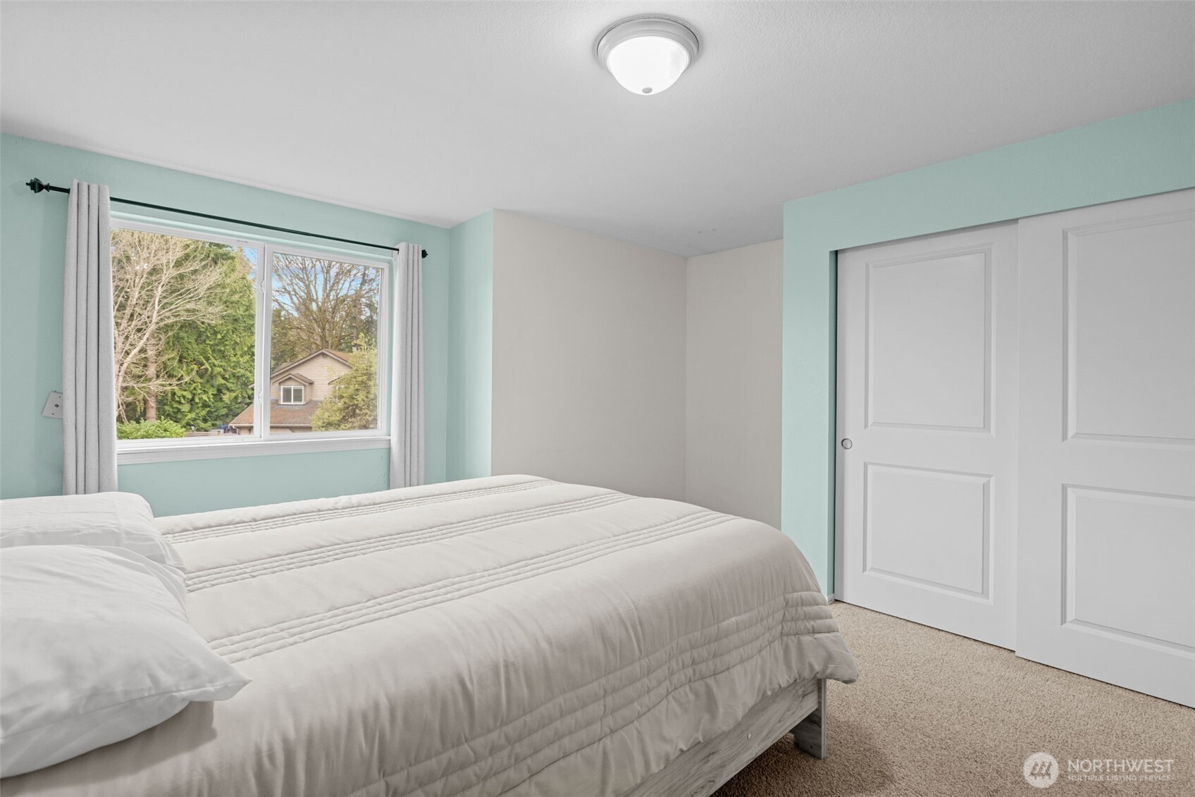 18429 20th Drive Southeast Bothell, WA 98012 - Photo 19 of 26 a large bed sitting in a bedroom next to a window