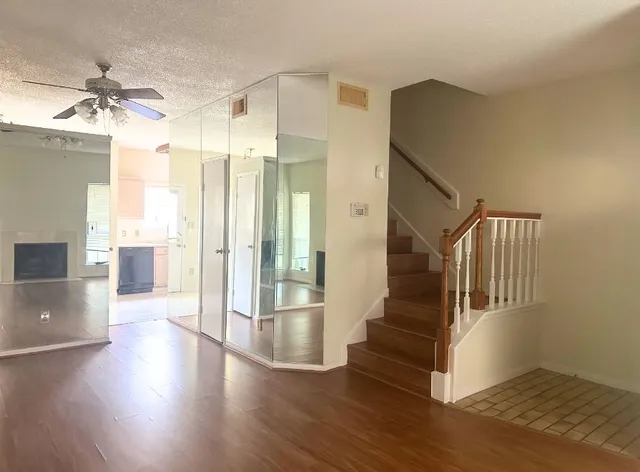 a view of an entryway with wooden floor and a living room