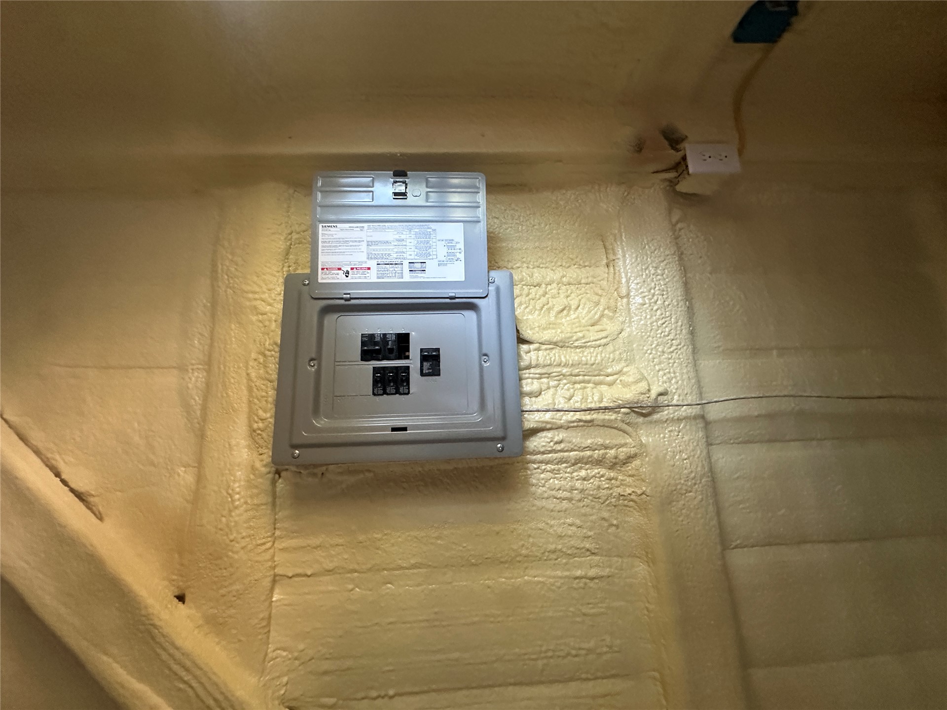 96567 South 4530 Road Vian, OK 74962 - Photo 10 of 13 Electrical service panel with exposed wiring, surrounded by spray foam insulation