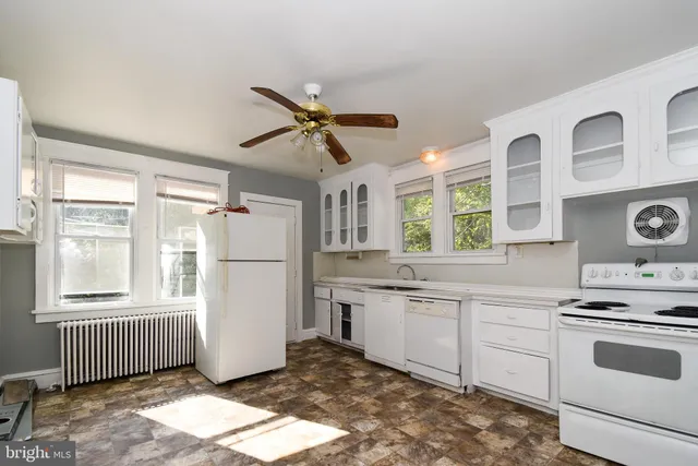 a kitchen with a stove a sink and a refrigerator