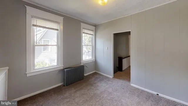 an empty room with windows and closet