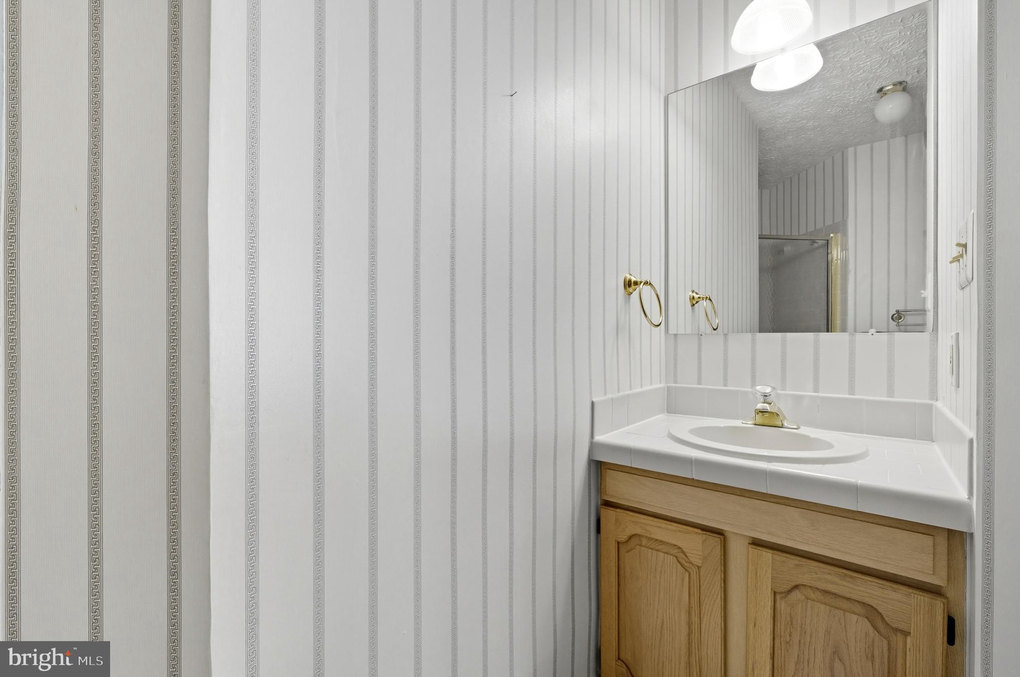 2605 Colpepper Road Abingdon, MD 21009 - Photo 41 of 95 a bathroom with a sink a vanity and a mirror