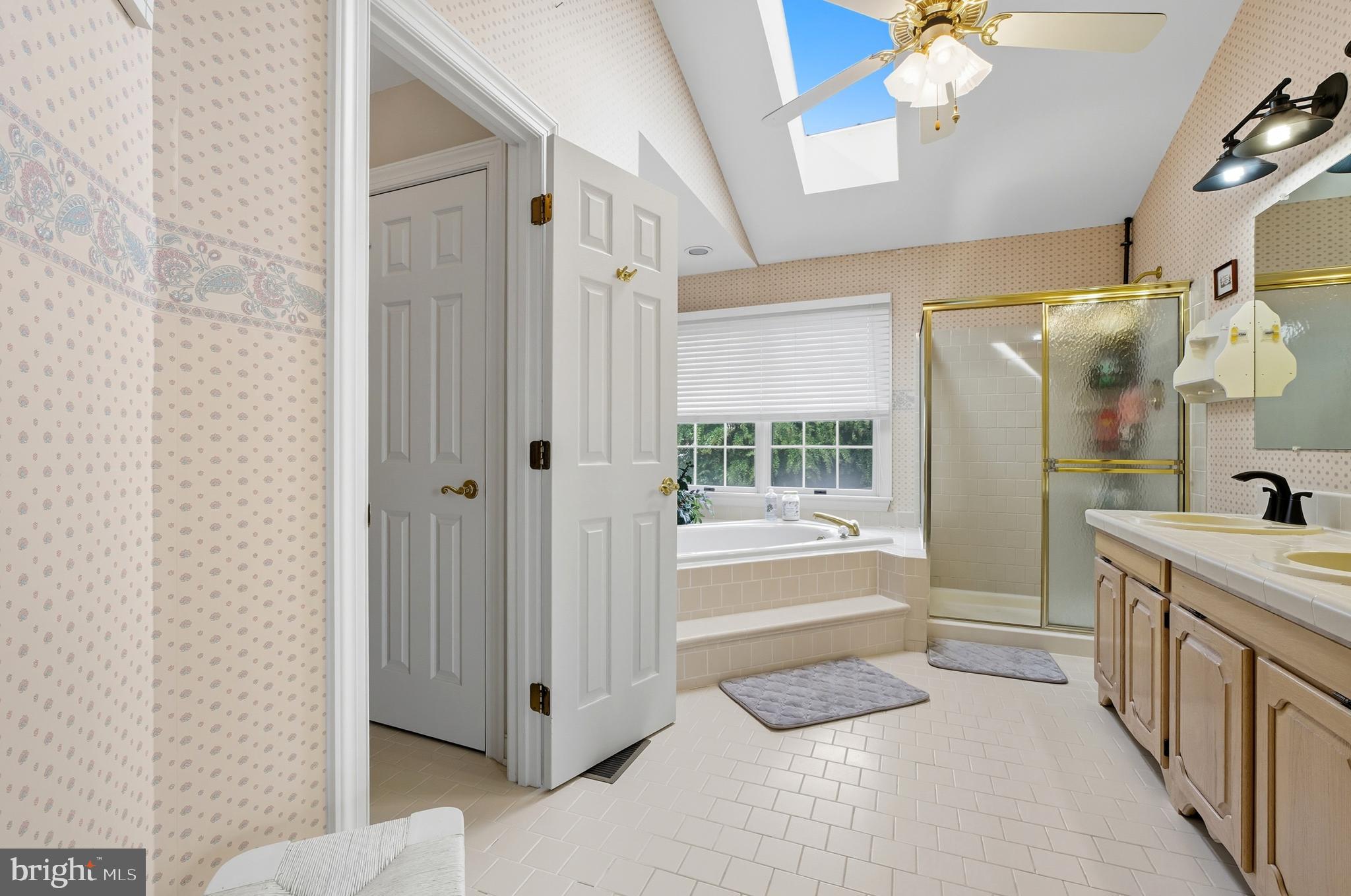 2605 Colpepper Road Abingdon, MD 21009 - Photo 48 of 95 a bathroom with a tub a sink and a large mirror