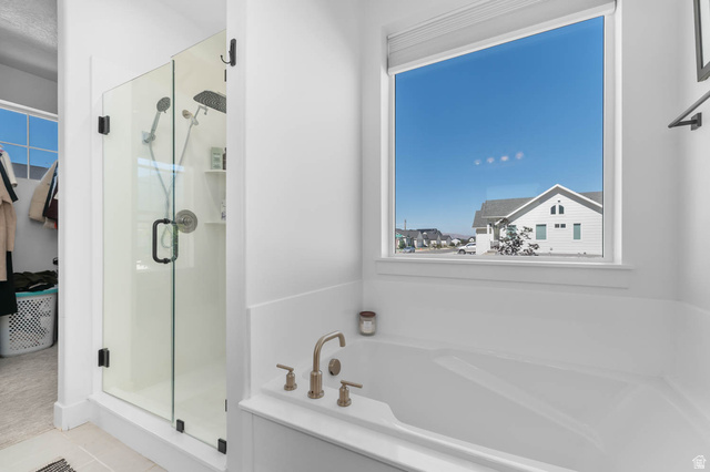 500 North 516th Street West, Unit 19 Mapleton, UT 84664 - Photo 10 of 41 Soaking tub with brushed nickel fixtures and a large window
