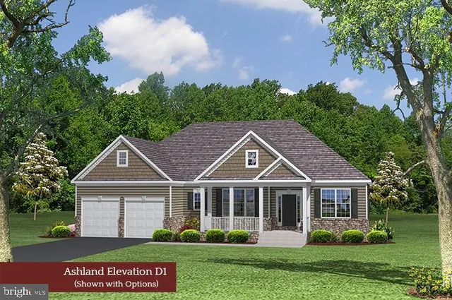 a front view of a house with a garden and trees