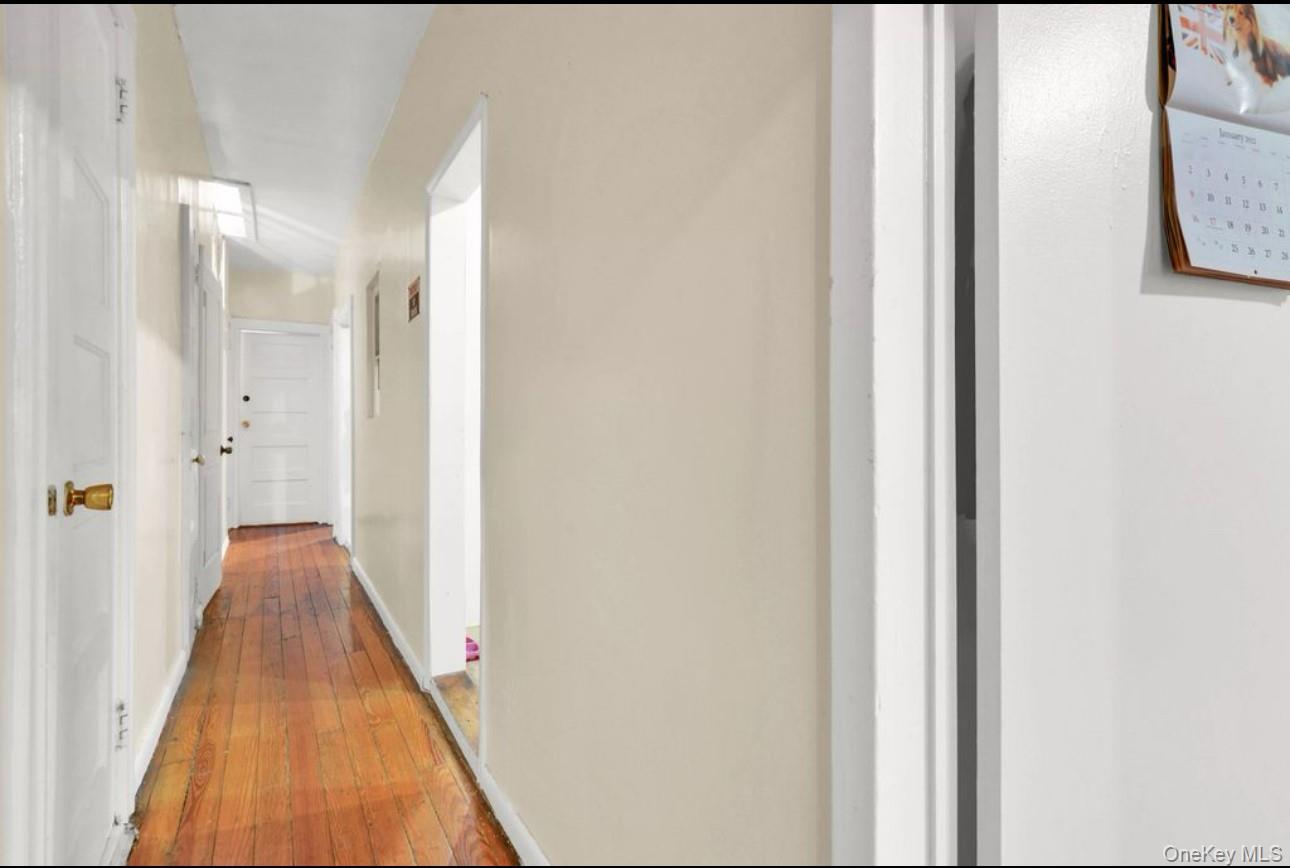 88-22 85th Street Queens, NY 11421 - Photo 13 of 33 Corridor with hardwood / wood-style flooring and baseboards