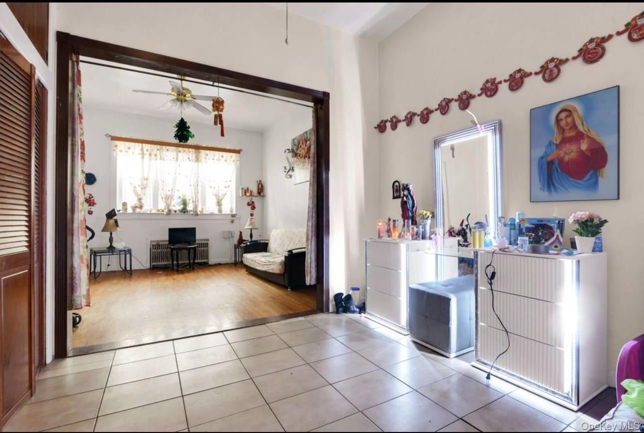 88-22 85th Street Queens, NY 11421 - Photo 7 of 33 Reception with ceiling fan