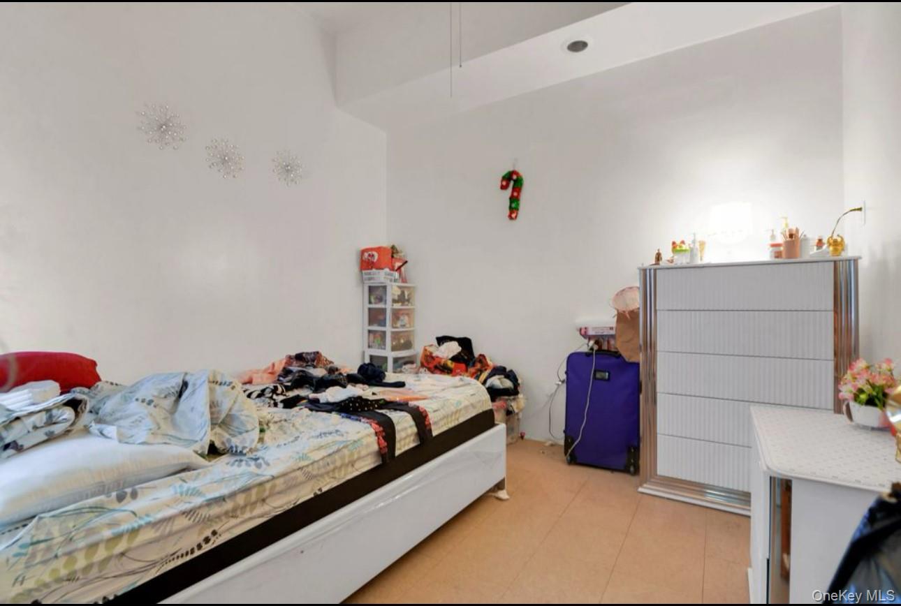 88-22 85th Street Queens, NY 11421 - Photo 8 of 33 Bedroom with light tile patterned floors