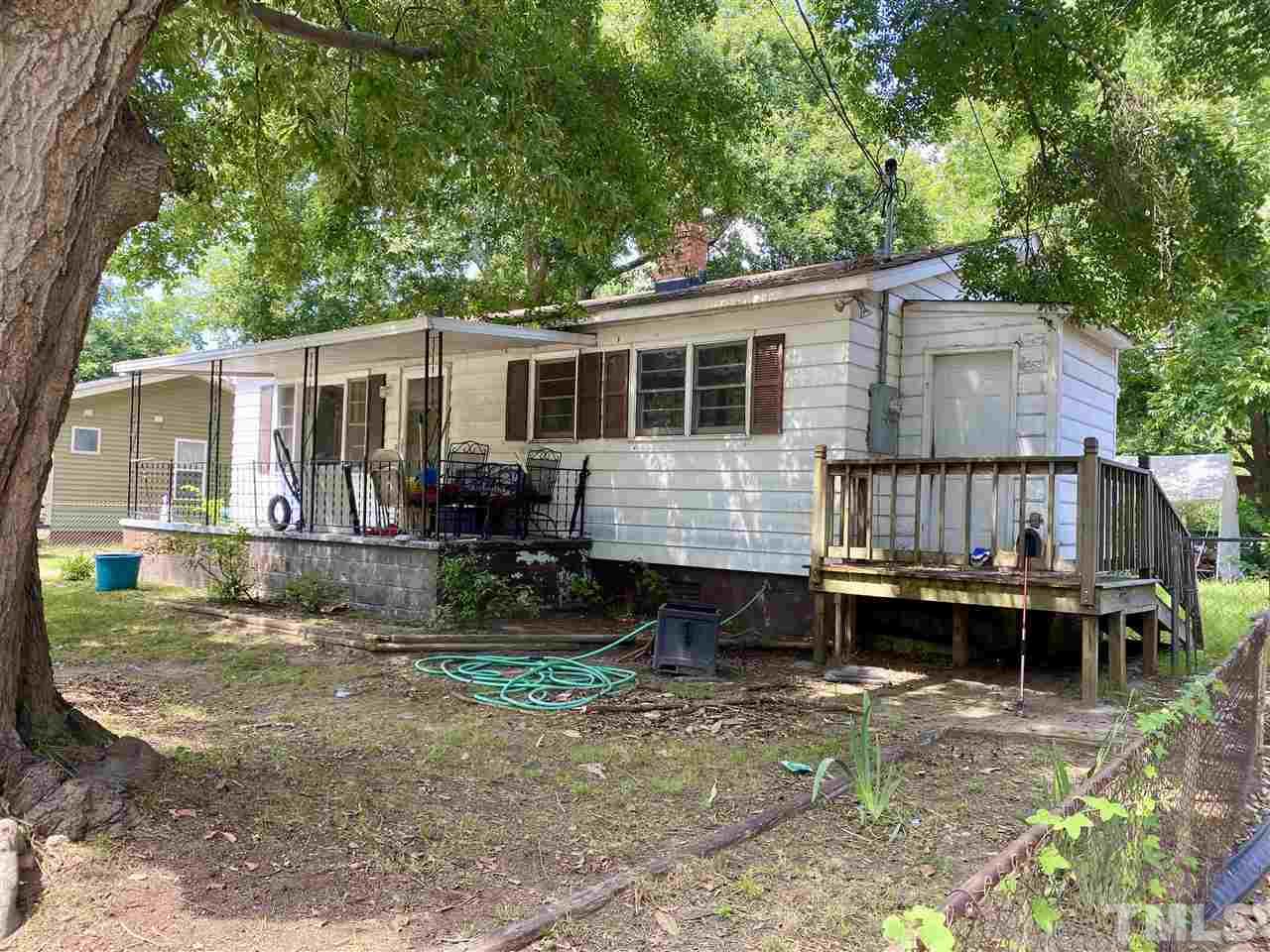 1005 Fuller Street Raleigh, NC 27603 - Photo 3 of 13 a view of a house with a yard chairs and a patio