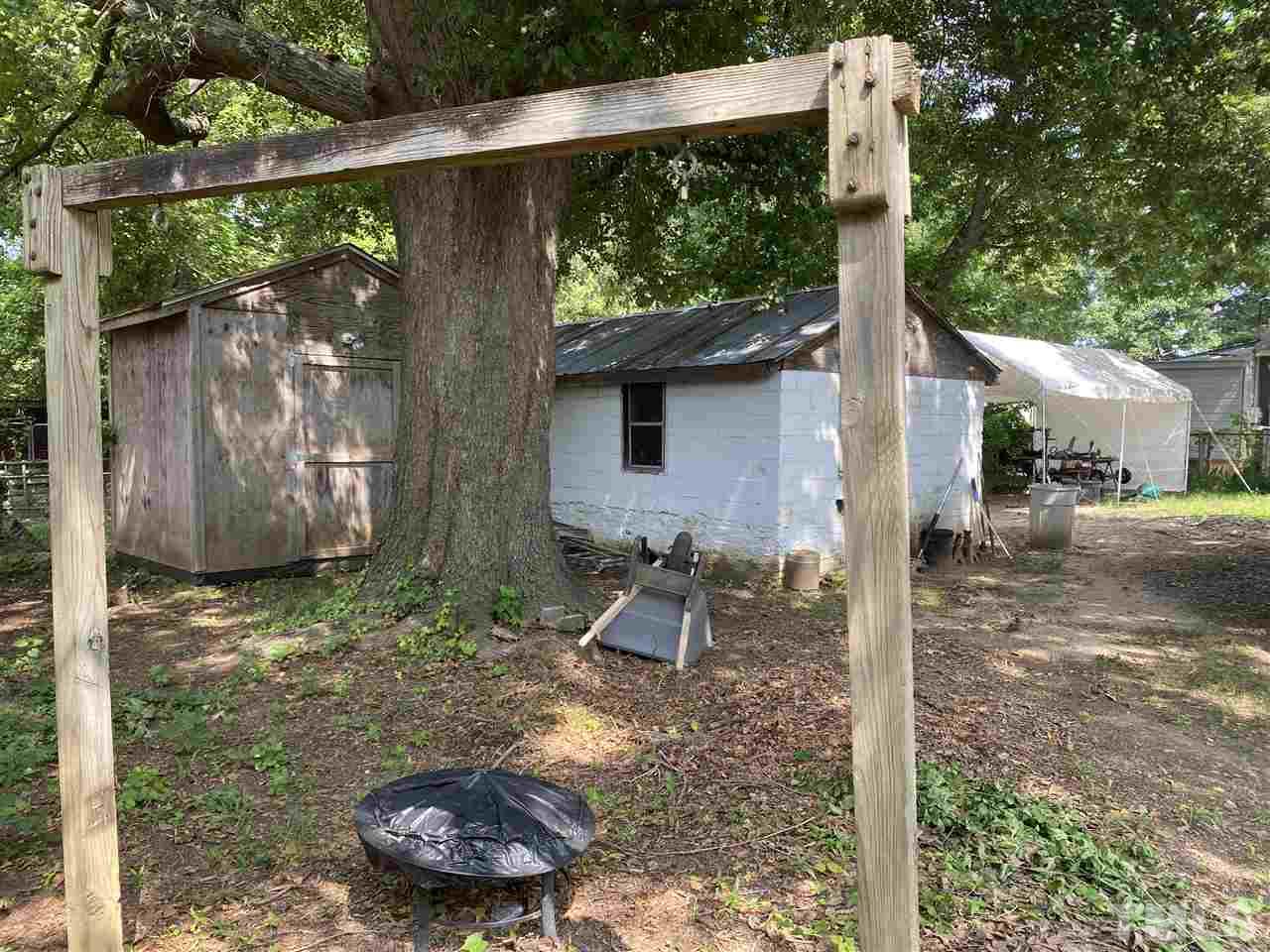 1005 Fuller Street Raleigh, NC 27603 - Photo 5 of 13 a backyard of a house with lots of green space and seating