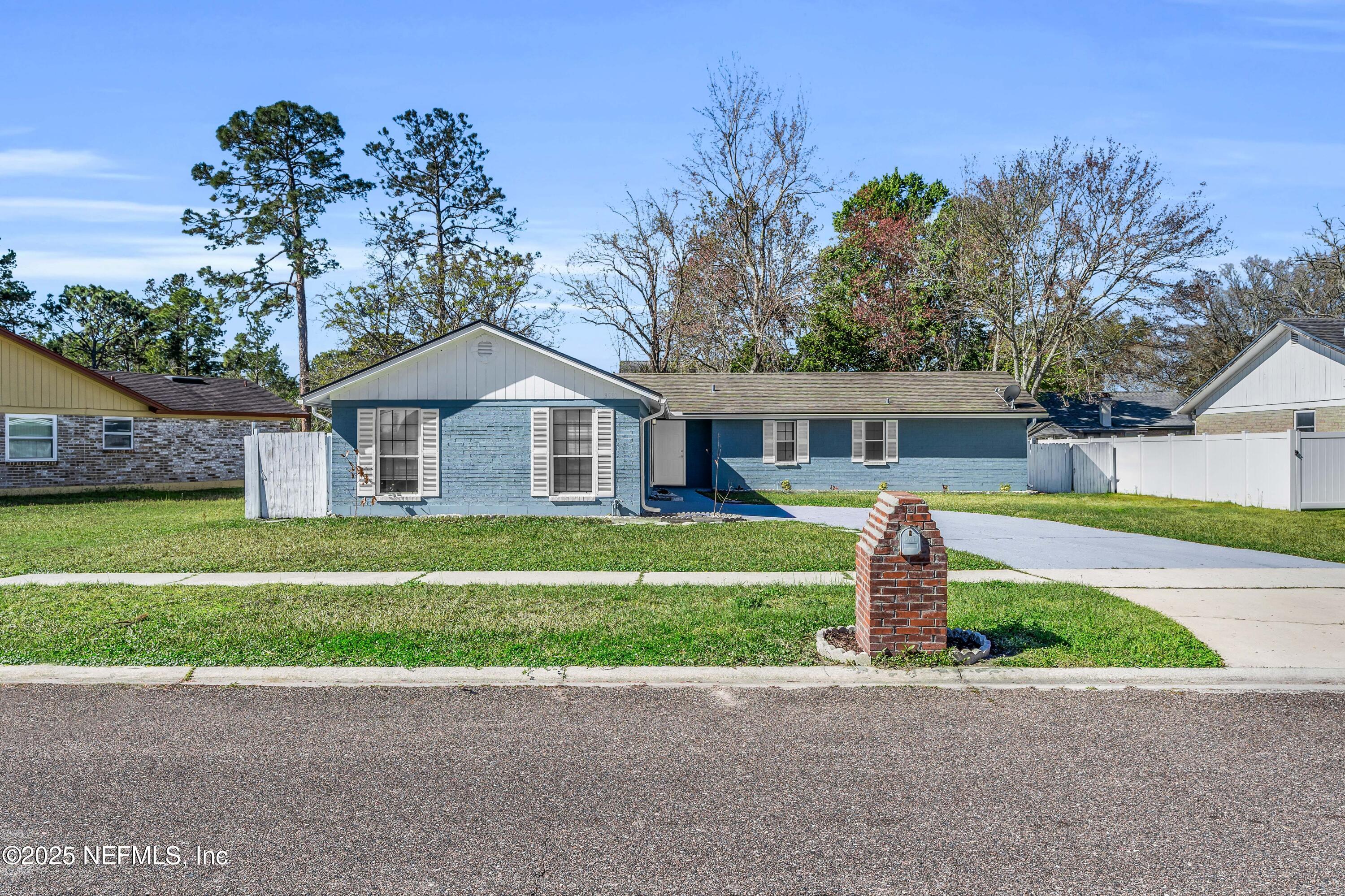 3950 Star Tree Road Jacksonville, FL 32210 - Photo 2 of 33 a front view of a house with a garden and yard