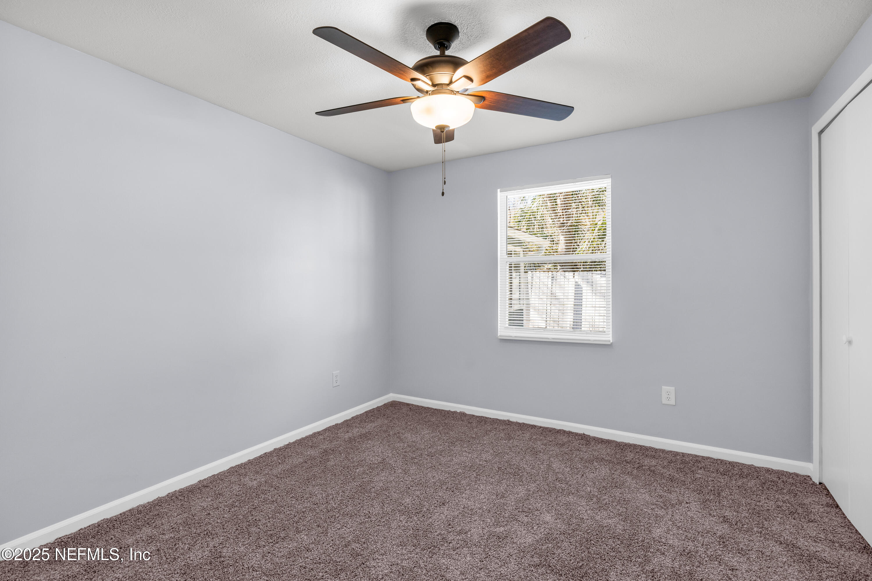 3950 Star Tree Road Jacksonville, FL 32210 - Photo 29 of 33 an empty room with a window and a fan