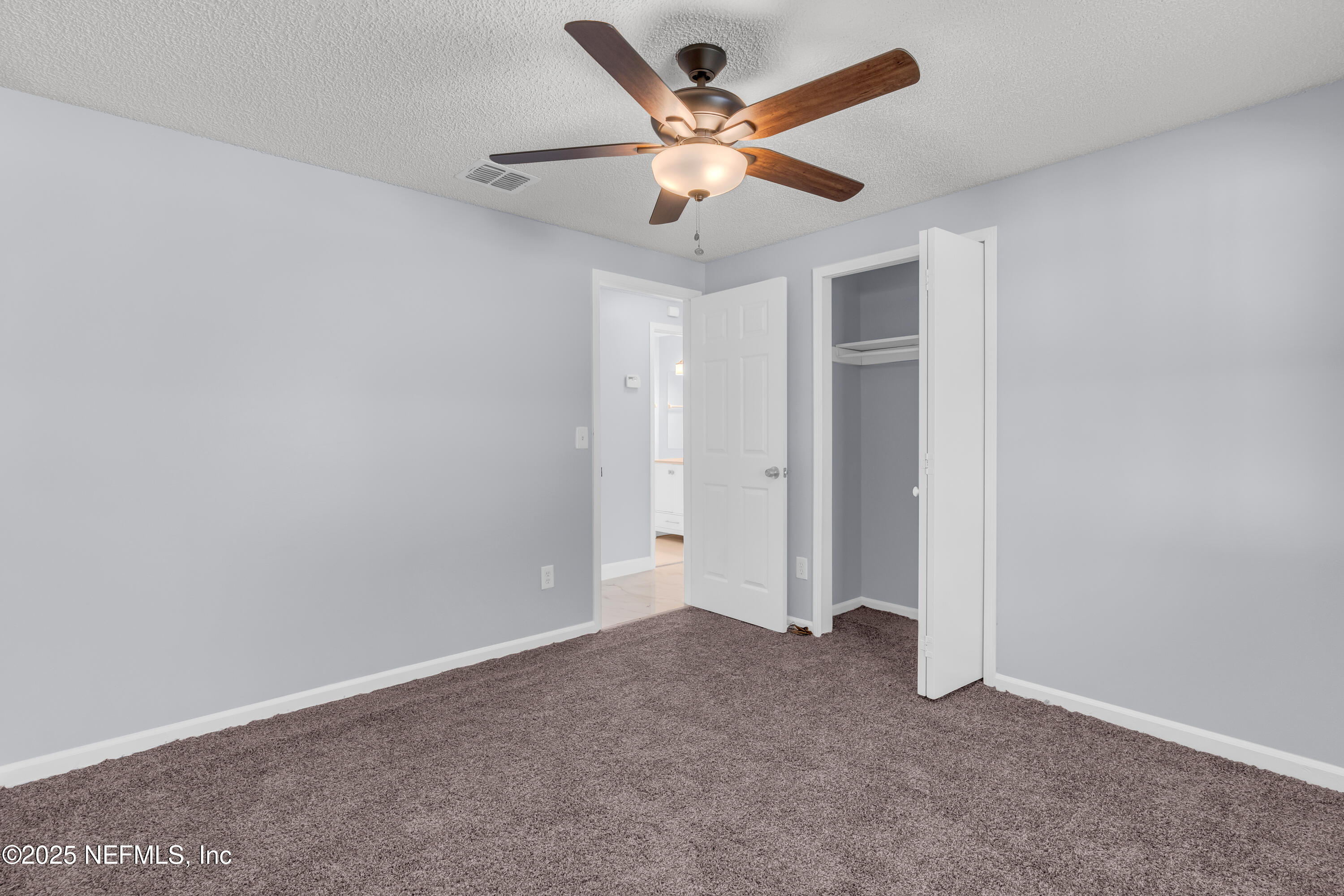 3950 Star Tree Road Jacksonville, FL 32210 - Photo 30 of 33 an empty room with a ceiling fan and a ceiling fan