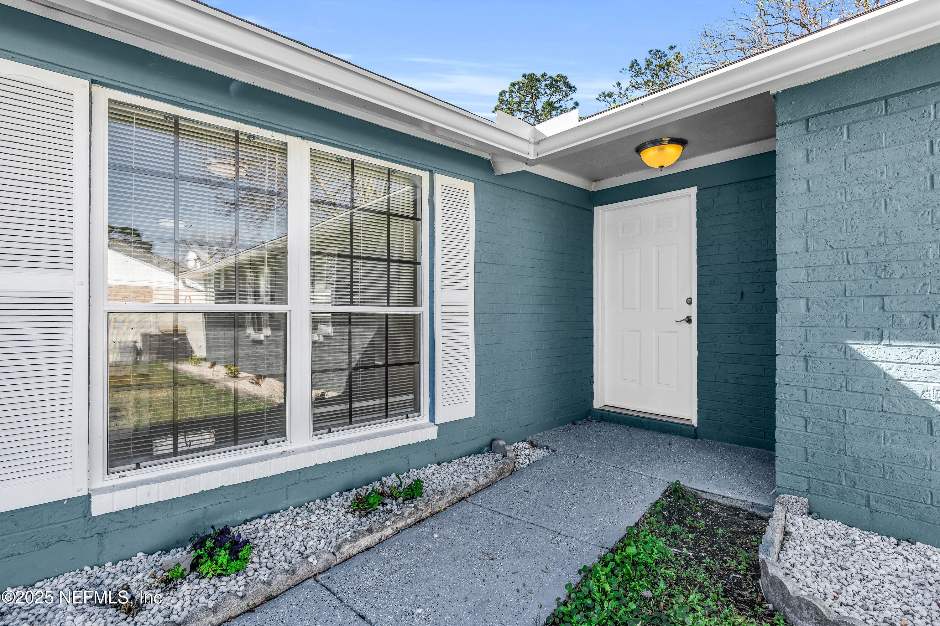3950 Star Tree Road Jacksonville, FL 32210 - Photo 4 of 33 a front view of a house with a garden