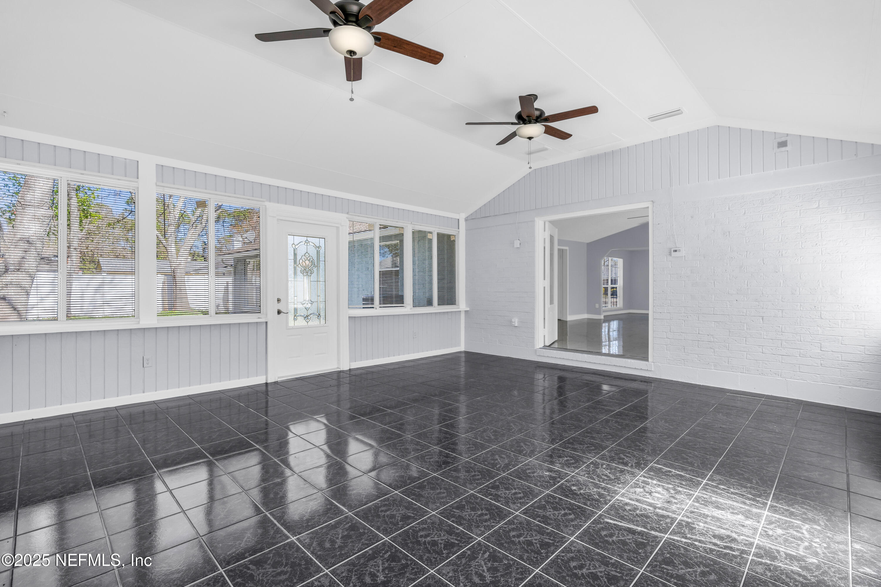 3950 Star Tree Road Jacksonville, FL 32210 - Photo 9 of 33 a view of an empty room with a window and wooden floor