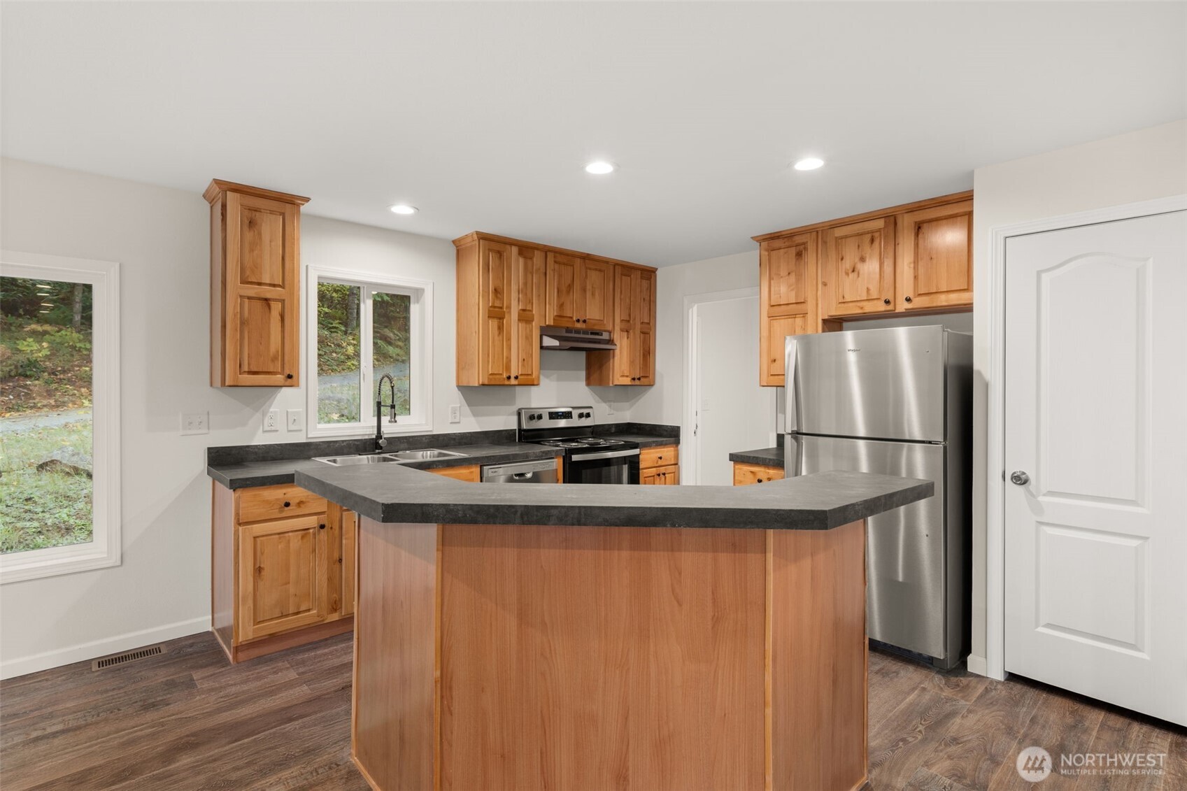 172 Boyd Road Randle, WA 98377 - Photo 12 of 30 a kitchen with stainless steel appliances granite countertop a refrigerator a stove and a sink with wooden floor