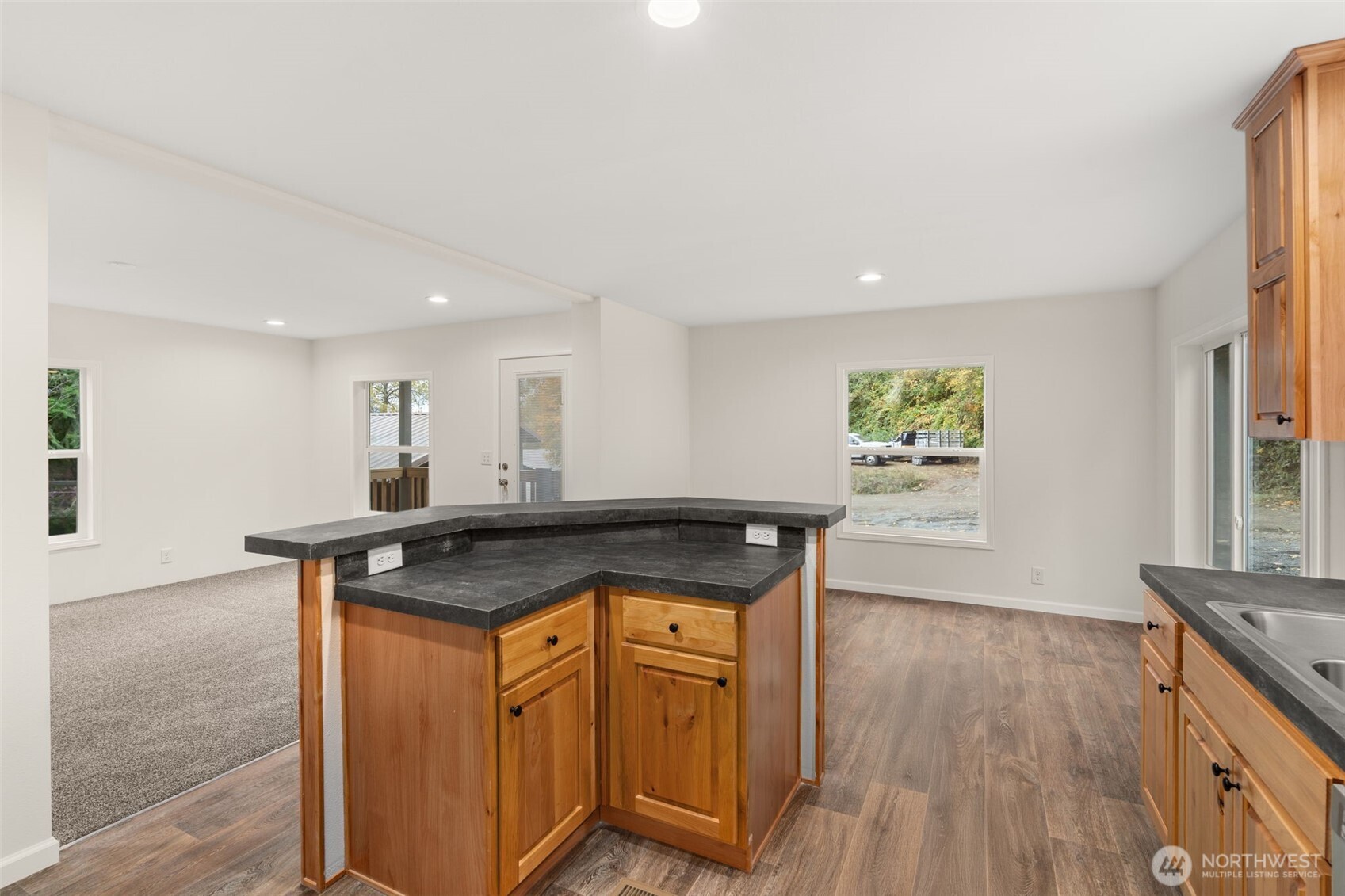 172 Boyd Road Randle, WA 98377 - Photo 14 of 30 a kitchen with stainless steel appliances granite countertop a stove a sink and a refrigerator with wooden floor