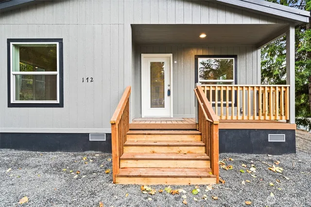 a view of entryway bedroom and hall with wooden floor