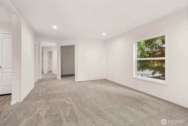 an empty room with windows and closet