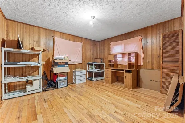 a bed room with a bed and a chair