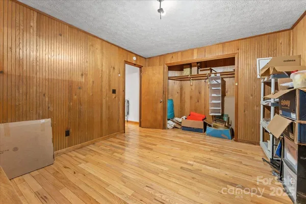 a living room with stainless steel appliances kitchen island granite countertop furniture a rug and a kitchen view