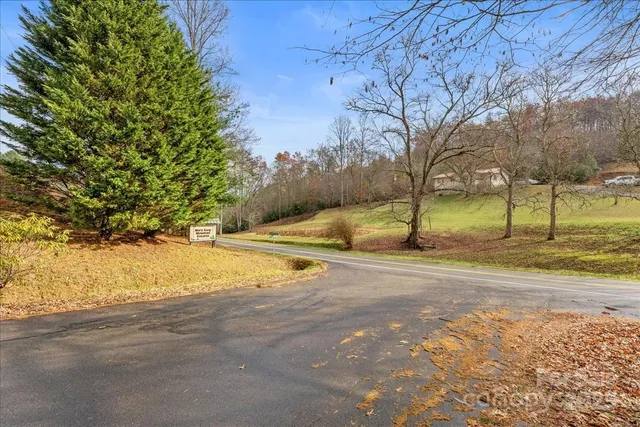 a view of a yard with wooden fence