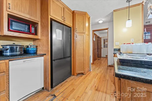 a kitchen with stainless steel appliances granite countertop a refrigerator and a stove top oven