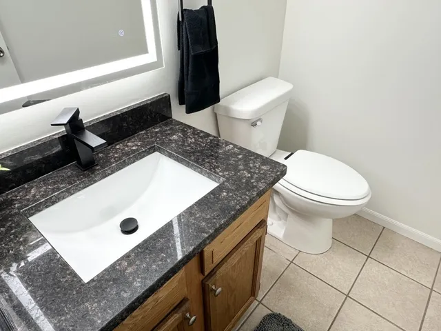 a white toilet sitting next to a white sink