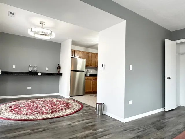 a view of kitchen with stainless steel appliances granite countertop a refrigerator and a stove