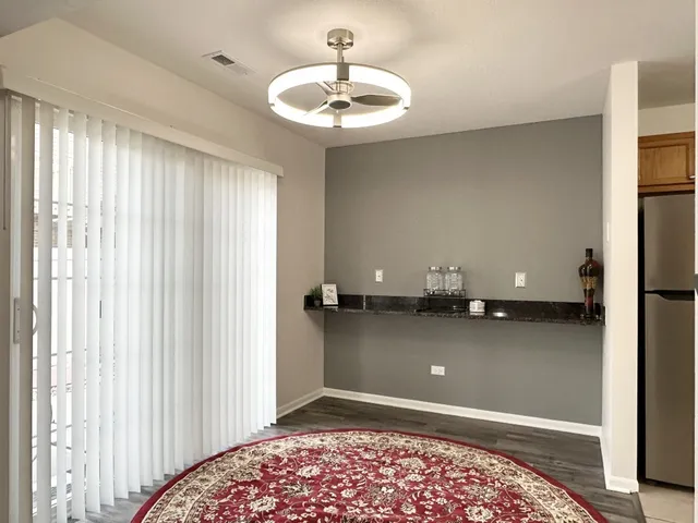 a view of a room with a chandelier fan and a window