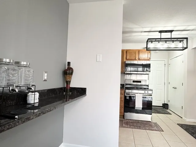a kitchen with stainless steel appliances granite countertop a sink and cabinets