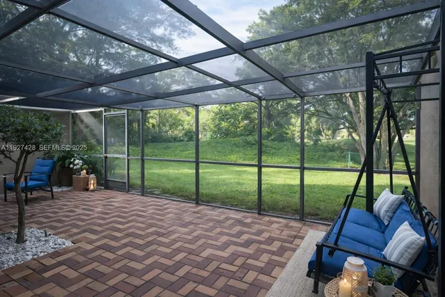 a view of a backyard with table and chairs under an umbrella