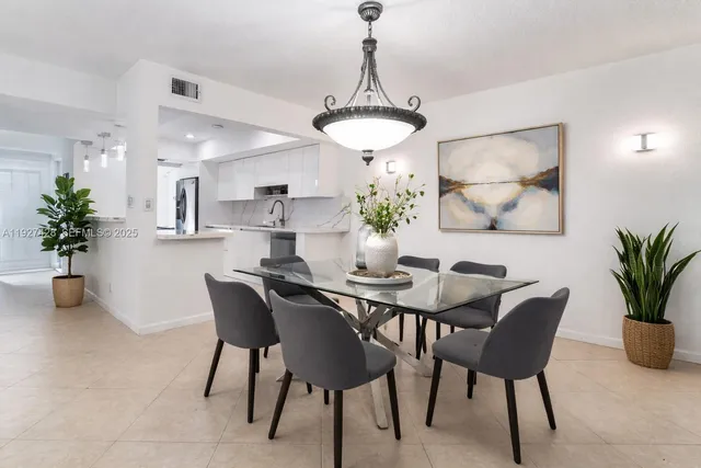 a dining room with furniture and potted plant
