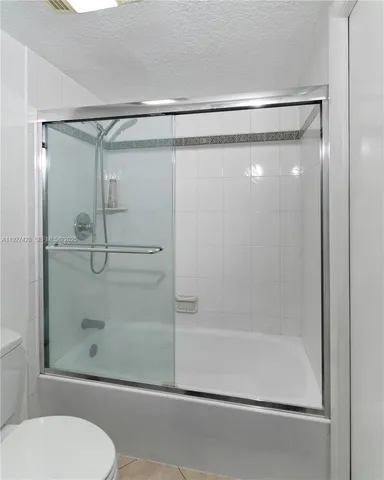 a bathroom with a shower and toilet