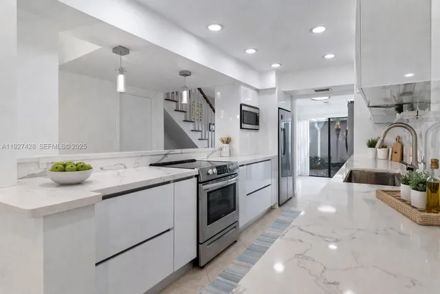 a kitchen with a sink appliances and cabinets
