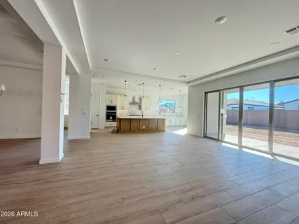 a view of kitchen and hall with wooden floor