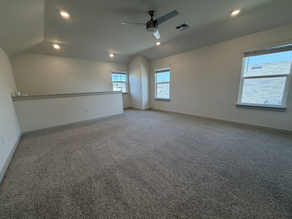 10708 Gonzales Ranger Pass Austin, TX 78754 - Photo 14 of 40 An airy loft with sloped ceilings and ample natural light offers versatile living space.