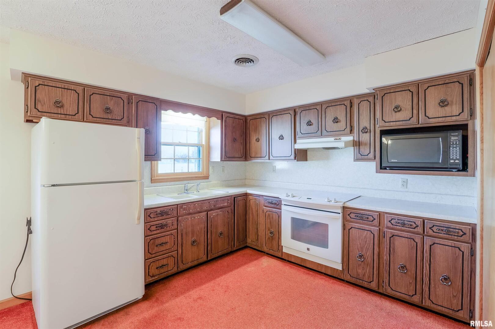 15546 Pittsburg Road Pittsburg, IL 62974 - Photo 3 of 48 a kitchen with stainless steel appliances granite countertop a refrigerator and a stove top oven
