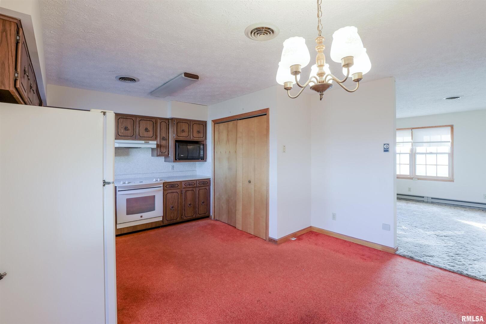 15546 Pittsburg Road Pittsburg, IL 62974 - Photo 6 of 48 a kitchen with stainless steel appliances granite countertop a white cabinets a sink and dishwasher