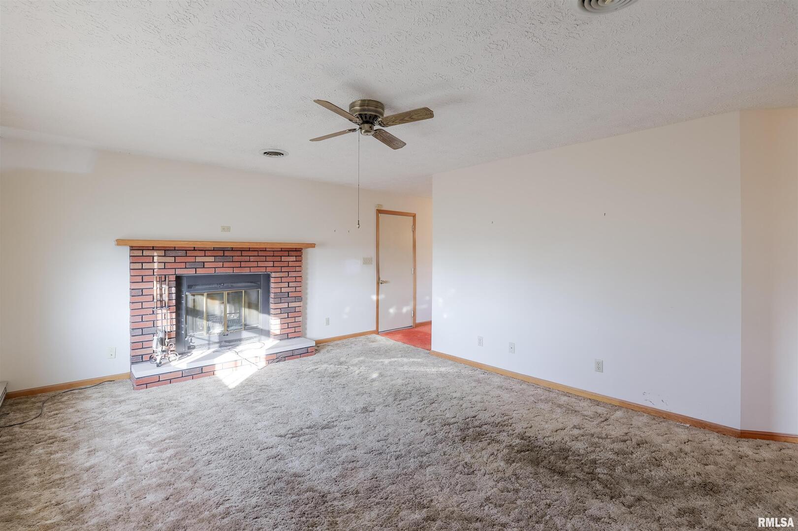 15546 Pittsburg Road Pittsburg, IL 62974 - Photo 9 of 48 a view of empty room with fireplace