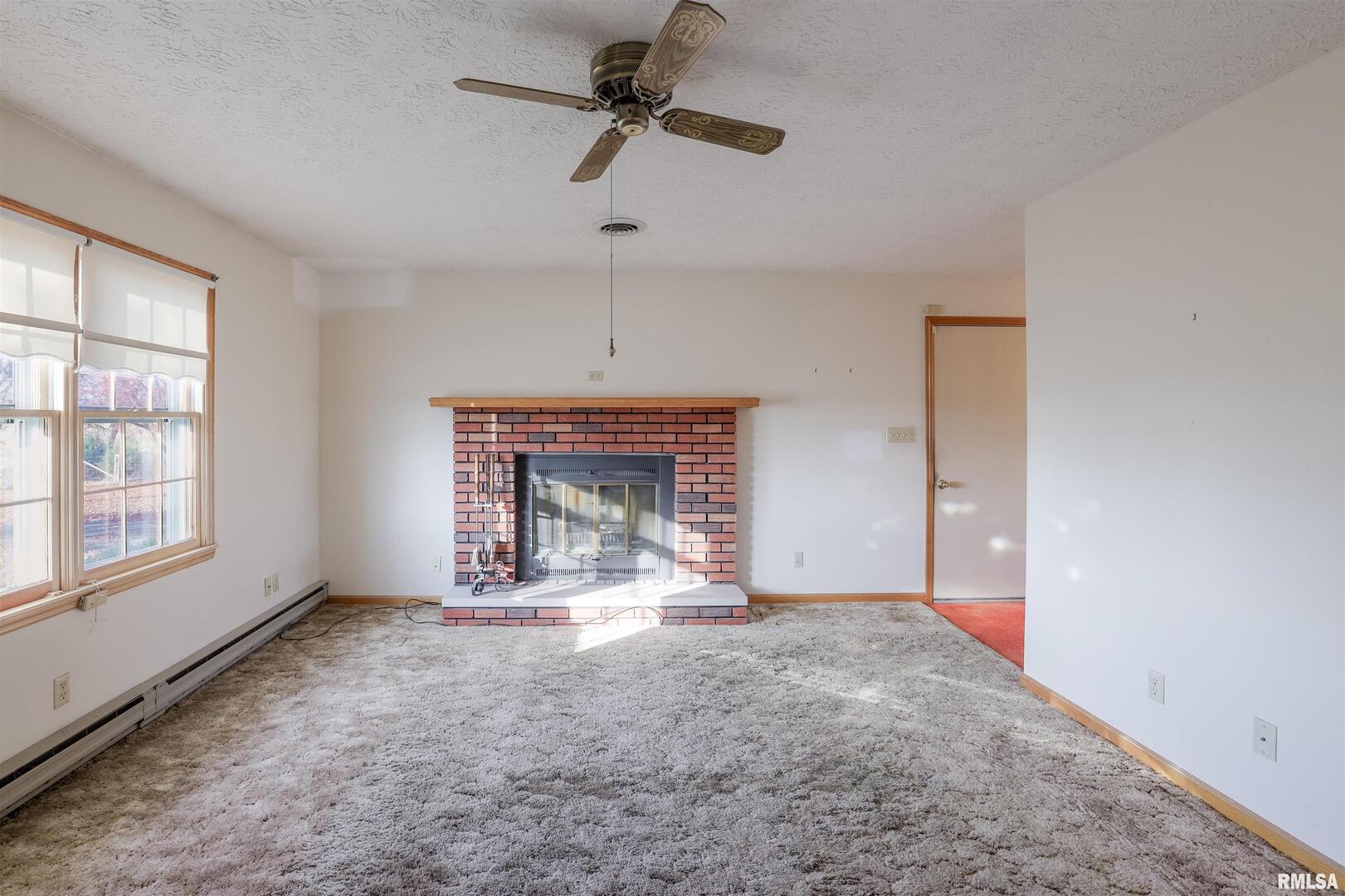 15546 Pittsburg Road Pittsburg, IL 62974 - Photo 10 of 48 a view of an empty room with a fireplace and a window