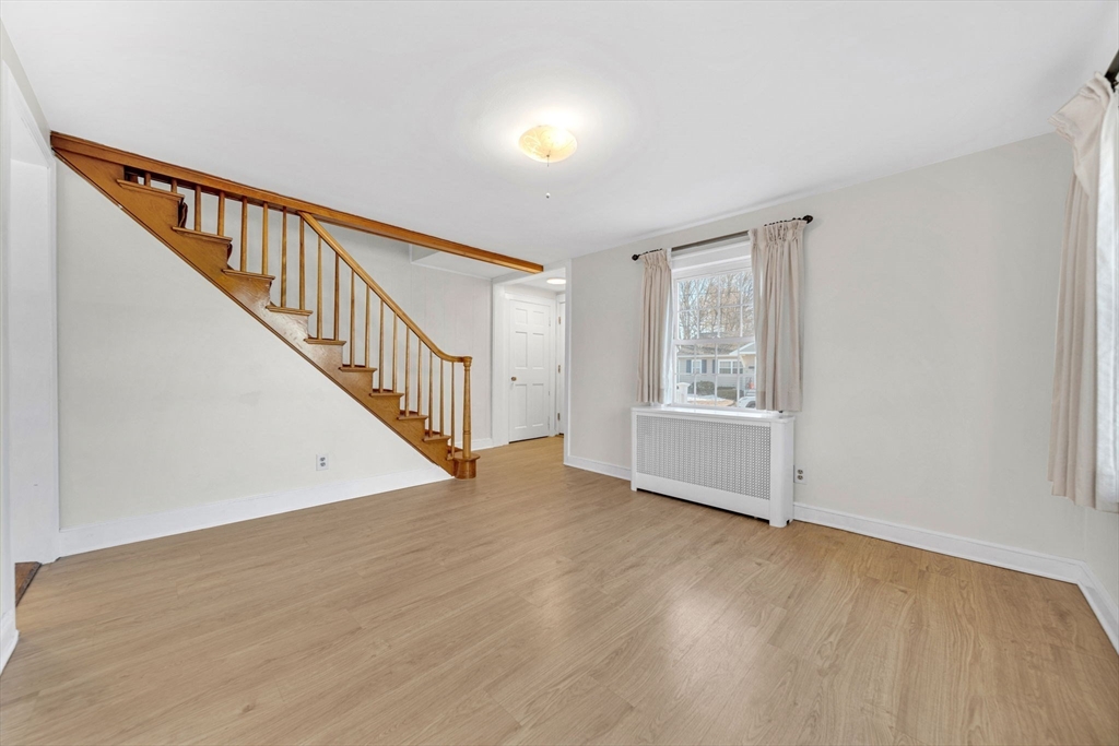 38 Longview Way Peabody, MA 01960 - Photo 11 of 42 a view of an empty room with wooden floor and stairs