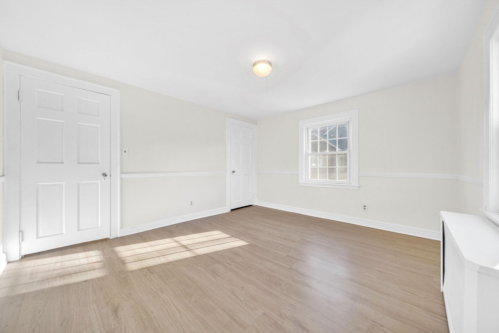 38 Longview Way Peabody, MA 01960 - Photo 16 of 42 an empty room with wooden floor and windows