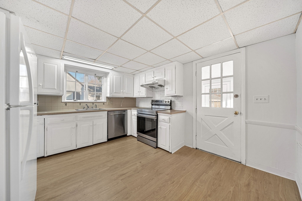 38 Longview Way Peabody, MA 01960 - Photo 6 of 42 a kitchen with white cabinets and white appliances