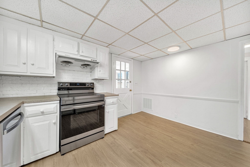 38 Longview Way Peabody, MA 01960 - Photo 7 of 42 a kitchen with a stove cabinets and wooden floor